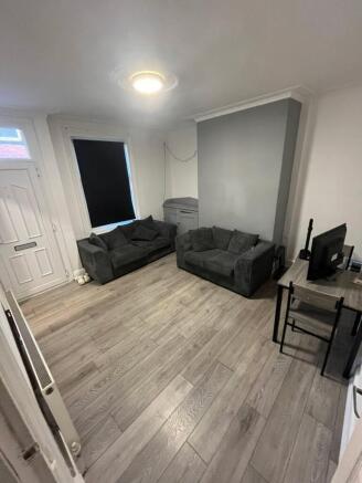 A contemporary and spacious living room featuri...