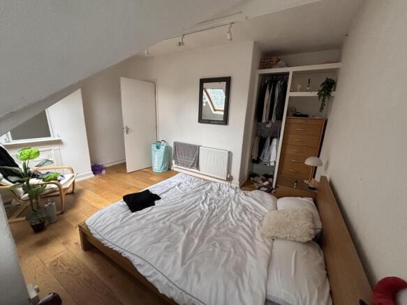 A bright and inviting master bedroom featuring ...