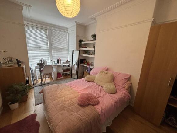 A cozy double bedroom featuring a neatly made b...