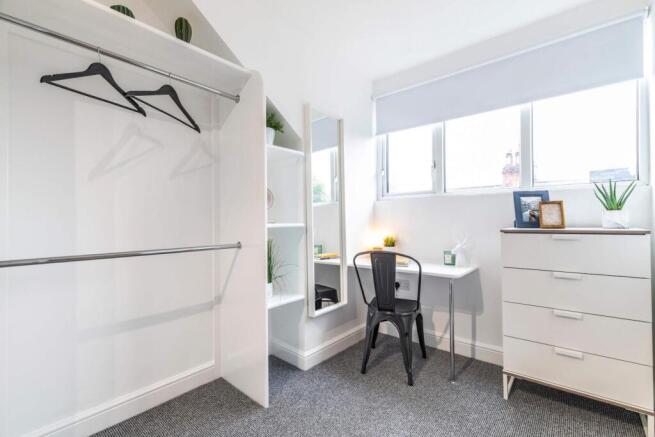 Bright and well-maintained bedroom featuring a ...