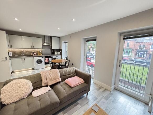 A bright and modern living room with ample natu...