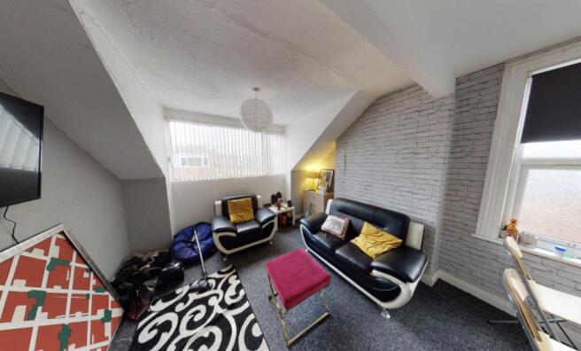 Bright and modern living room featuring a comfo...