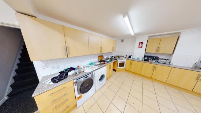 Bright, modern fitted kitchen with tiled floor,...