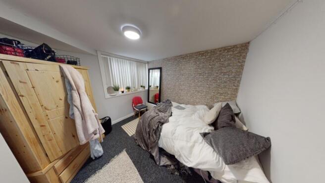 A cozy and well-maintained double bedroom featu...