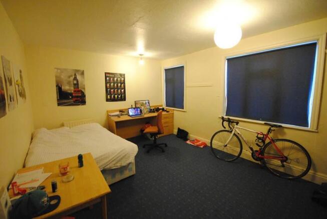 A well-maintained bedroom featuring a comfortab...