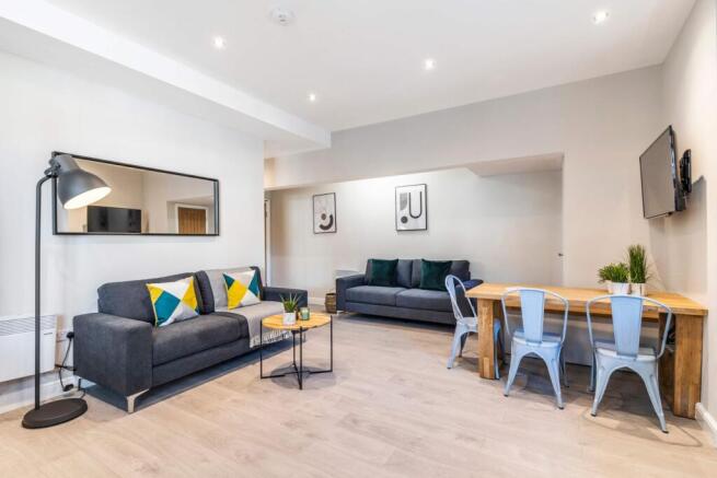 A modern, spacious living room featuring comfor...