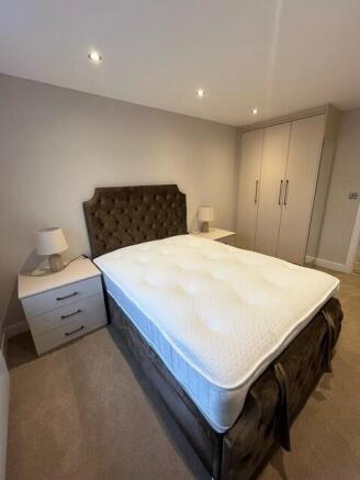 A spacious, well-maintained master bedroom feat...