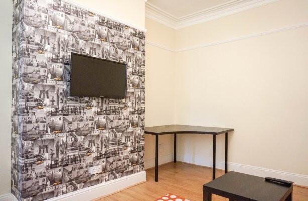 A well-maintained living room featuring a strik...