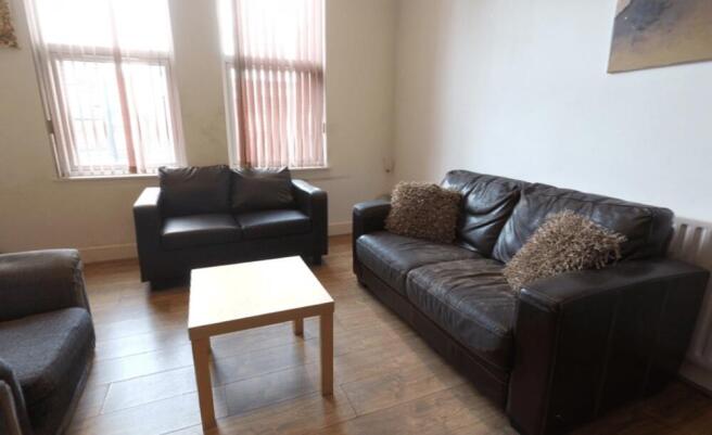 A well-lit, inviting living room featuring comf...