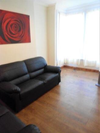 A bright and welcoming living room featuring a ...