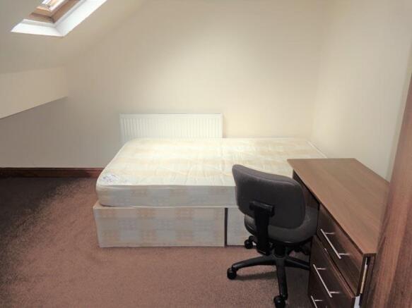 A bright and tidy living room featuring ample n...