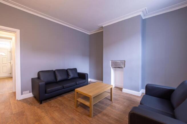 Bright, neutrally decorated living room with tw...