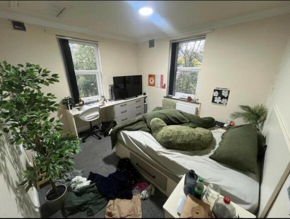 Bright and spacious living room with large wind...