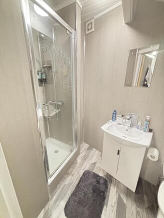 A clean and modern bathroom featuring a shower ...