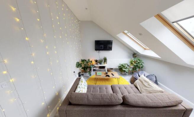 Bright and spacious living room featuring an el...