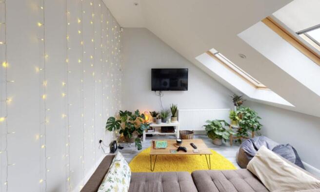 Bright and welcoming living room with ample nat...