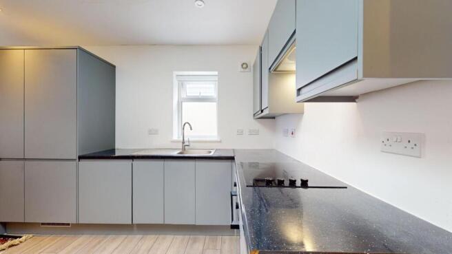 Modern fitted kitchen with sleek grey cabinetry...