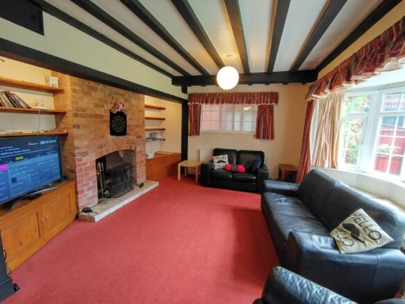 Bright, characterful living room with exposed b...