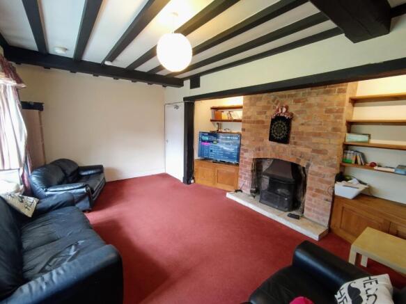Spacious living room with exposed ceiling beams...