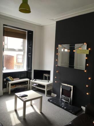 Bright, modern living room with a feature dark-...