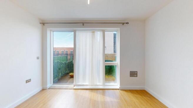 Bright and airy living room featuring large gla...