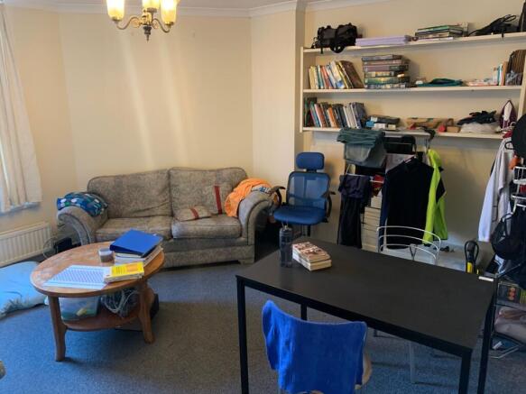 Bright communal living room with a comfortable ...