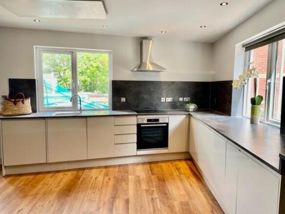 Bright modern kitchen with large windows, sleek...