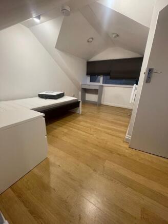 A cozy, well-maintained single bedroom with lig...