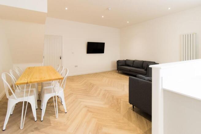 Bright, modern open-plan living area with light...