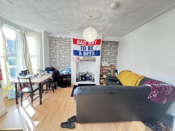 Bright and stylish living room featuring a comf...