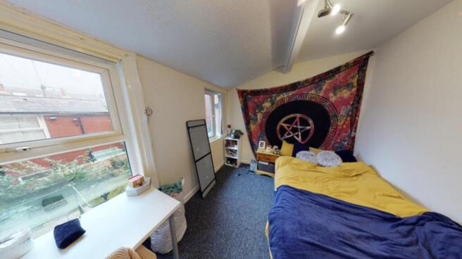 A bright and inviting bedroom with natural ligh...