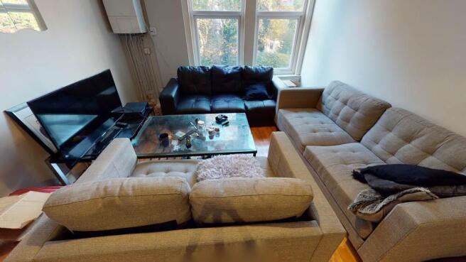 A spacious and inviting living area featuring m...