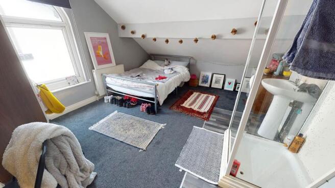 A bright and inviting double bedroom featuring ...