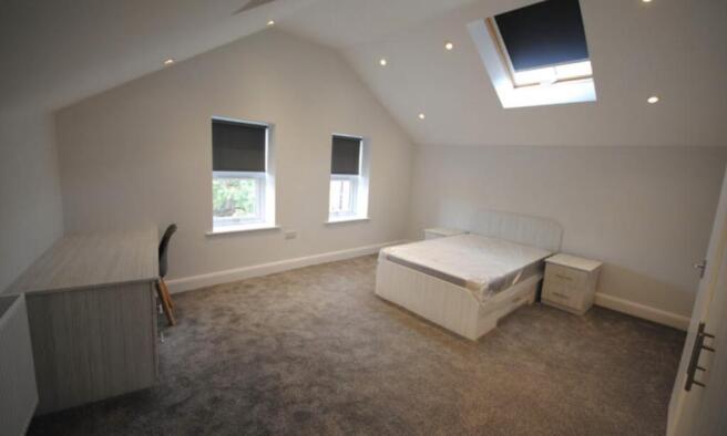 Bright and spacious master bedroom featuring a ...