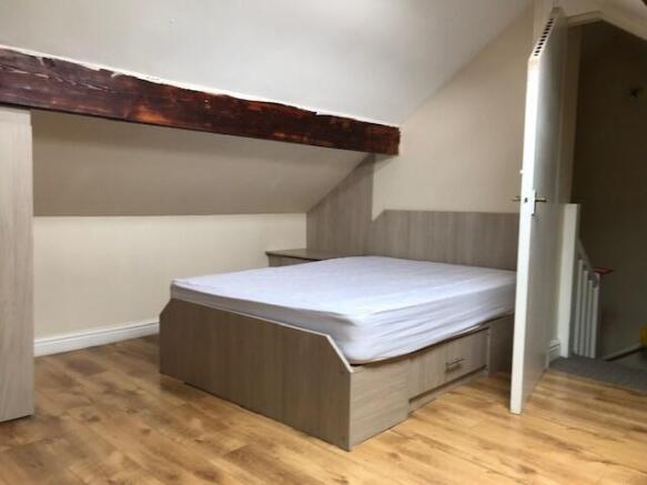 A cozy single bedroom with a comfortable bed, l...