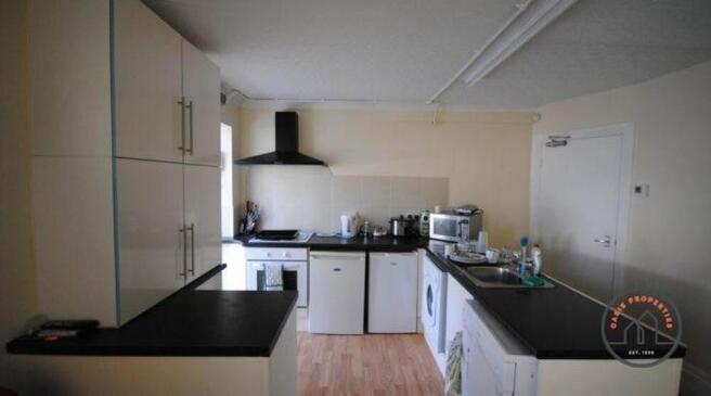 Bright fitted kitchen with modern black worktop...