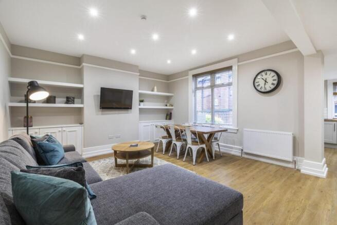 Bright, modern living room with a large L-shape...