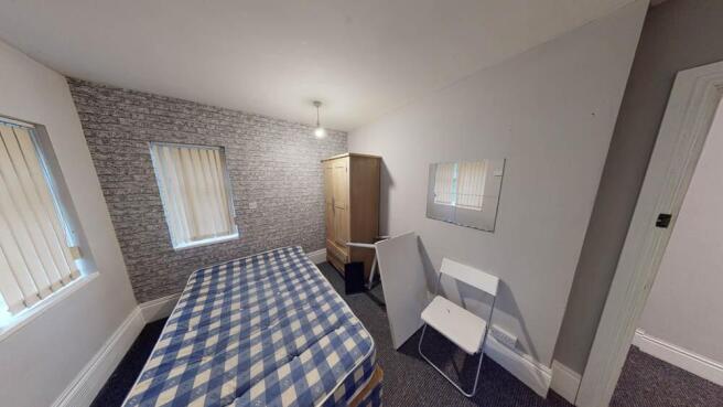 A bright and inviting bedroom featuring a doubl...