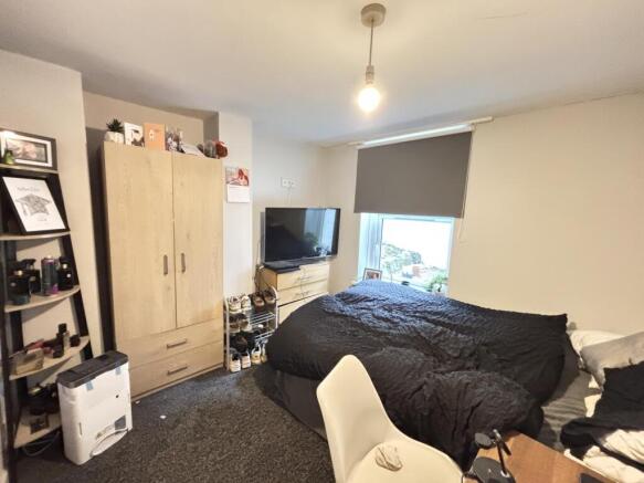 A well-maintained bedroom featuring a comfortab...