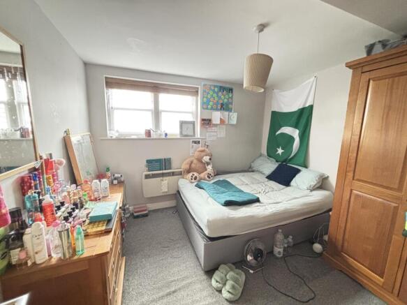 A spacious and inviting master bedroom featurin...