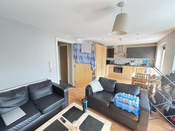 A spacious, modern living room featuring comfor...