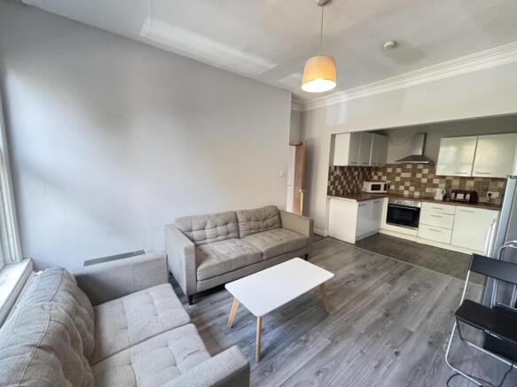 A modern, well-lit living room with comfortable...