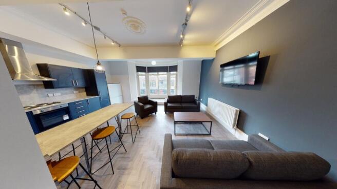 A spacious and modern living room featuring com...