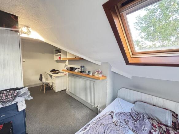 A spacious and well-maintained bedroom featurin...