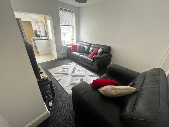 Bright, simply styled living room with two blac...