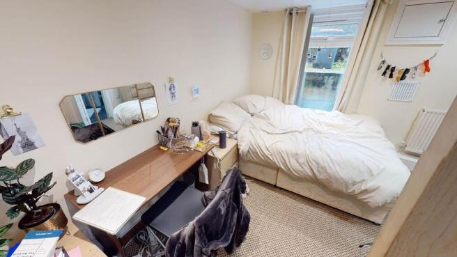 A cozy and well-lit double bedroom featuring a ...