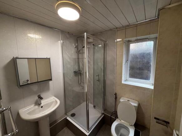 A clean and functional bathroom with a shower e...