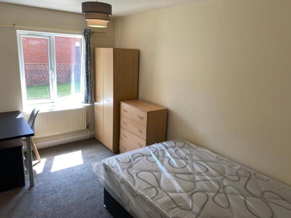 Bright, neatly presented furnished bedroom with...