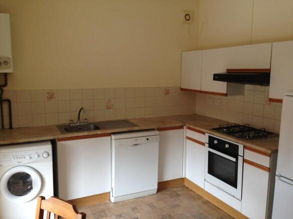 A functional kitchen area featuring a sink, dis...