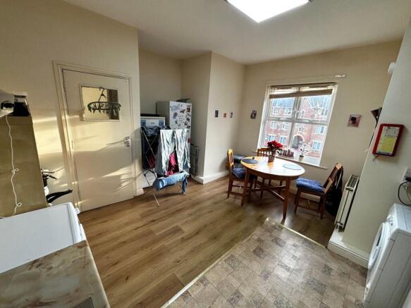 Bright kitchen/dining area with a round wooden ...